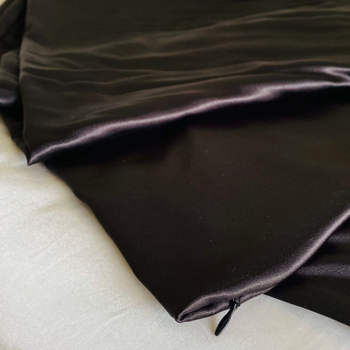 Close-up of the black satin Cooling Silk Cover with hidden zip