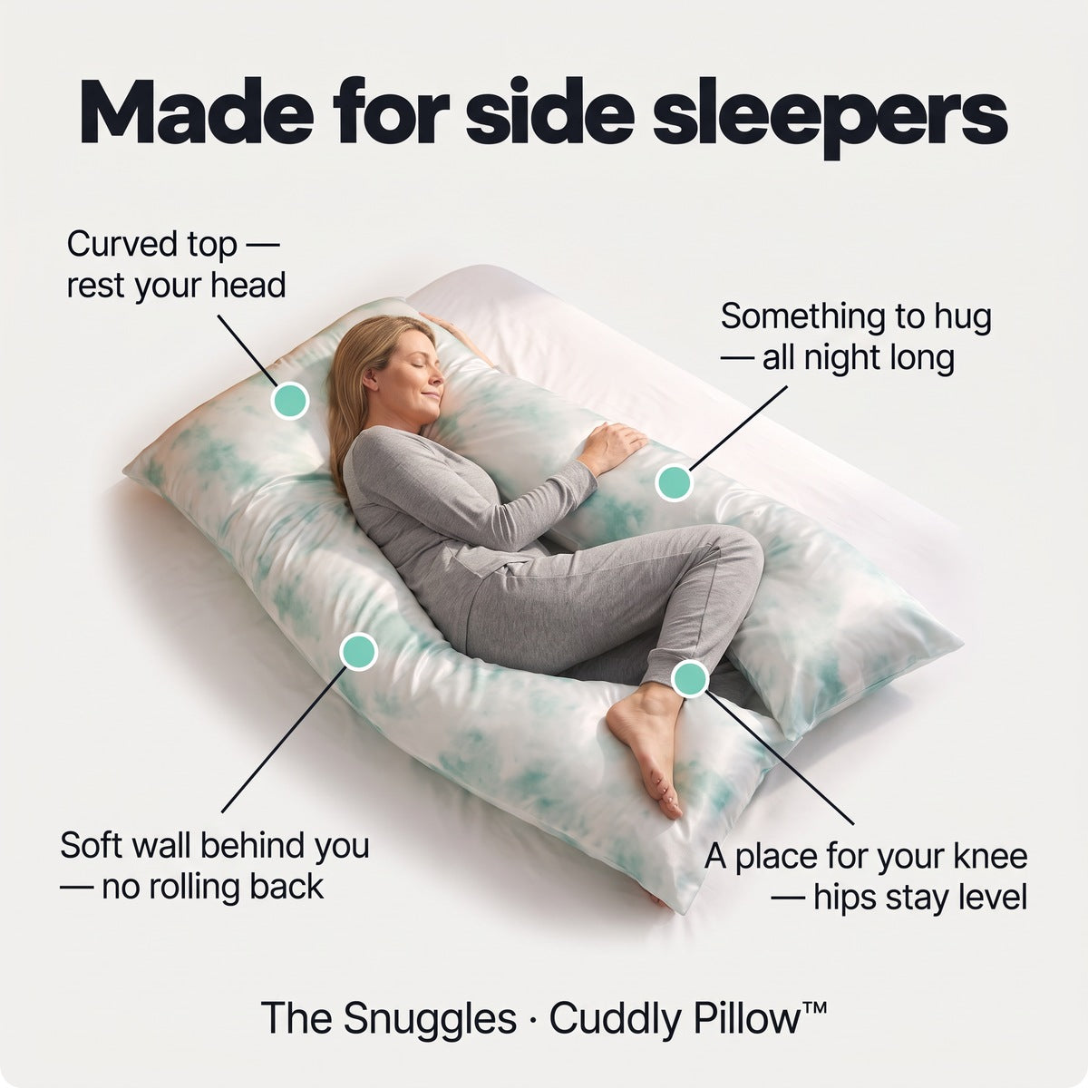 Made for side sleepers: woman on her side in the Cuddly Pillow with a sky satin silk cover, curved top for the head, front to hug, soft wall behind, space for the knee