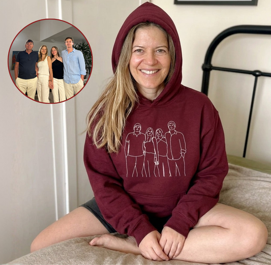 Woman wearing a burgundy Custom Hoodie by The Snuggles with embroidered family line art