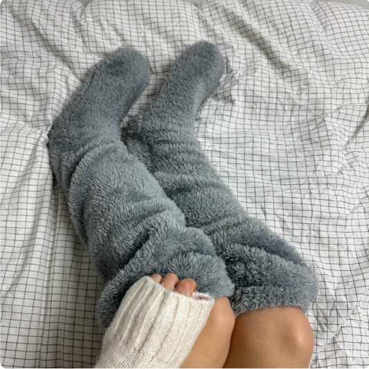 Fuzzy Socks™ by The Snuggles, grey knee-high fluffy socks worn in bed