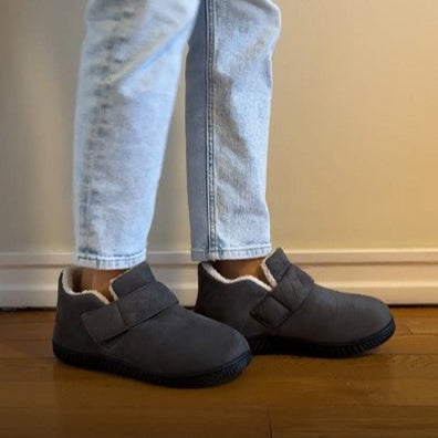 Person wearing grey Orthopedic Healing Slippers with jeans