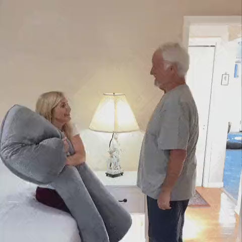 Woman sleeping on the Cuddly Pillow™ U-shaped body pillow on a sofa
