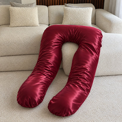Red Satin Silk Cover on a U-shaped body pillow, glossy wine-red silk draped over a cream sofa