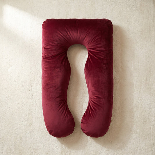 Red Satin Silk Cover on a U-shaped Cuddly Pillow, overhead view on an ivory rug