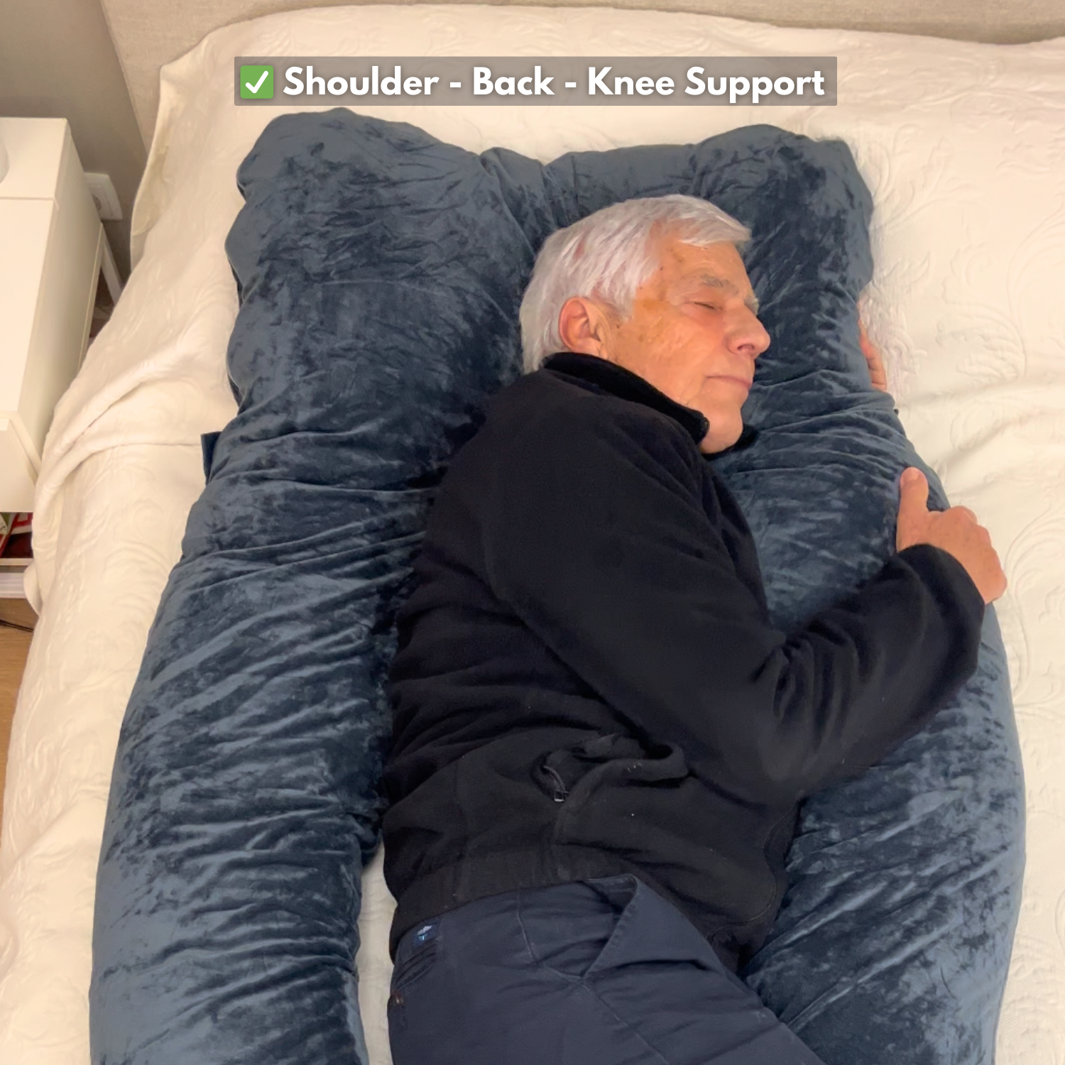 Man sleeping on The Sidelock Pillow™ U-shaped body pillow: shoulder, back and knee support